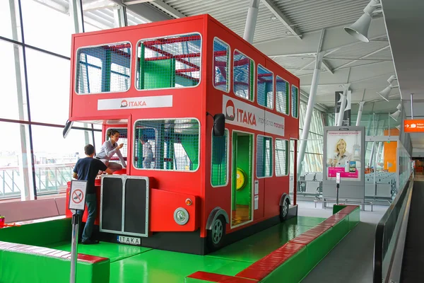 Kids playground-bus in Warsaw Chopin Airport, Poland