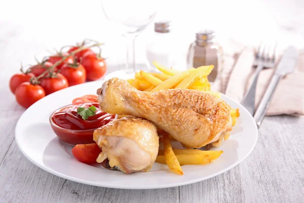 Grilled chicken legs and french fries