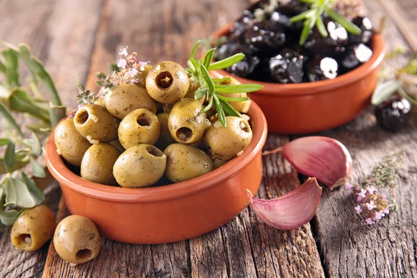 Green and black olives with herbs