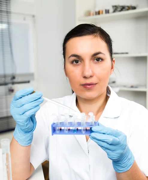 Female Scientist Analyzing Sample In Laboratory.laboratory assistant analyzing a sample.