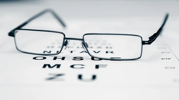 Clear Black modern glasses on a eye sight test chart