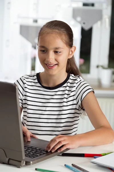 Beautiful girl working on her school project at home.