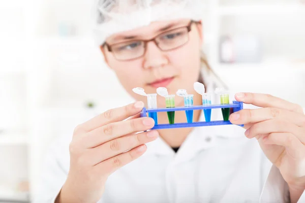 Laboratory assistant analyzing a liquid