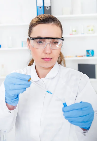 Female researcher with glass equipment in the lab