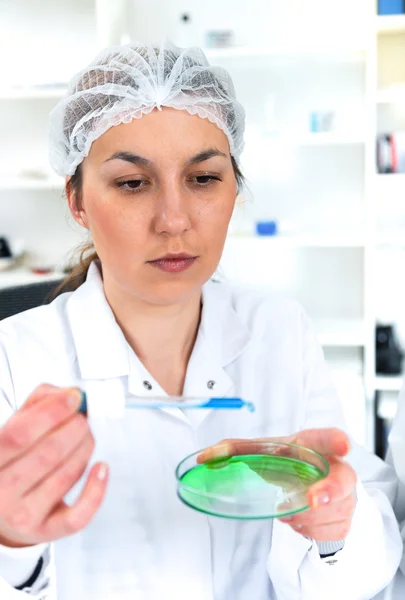 Team of scientists in a laboratory working on chemical testing