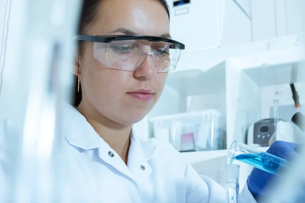 Laboratory assistant analyzing a sample