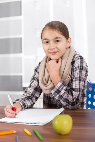 Beautiful girl working on her school project at home