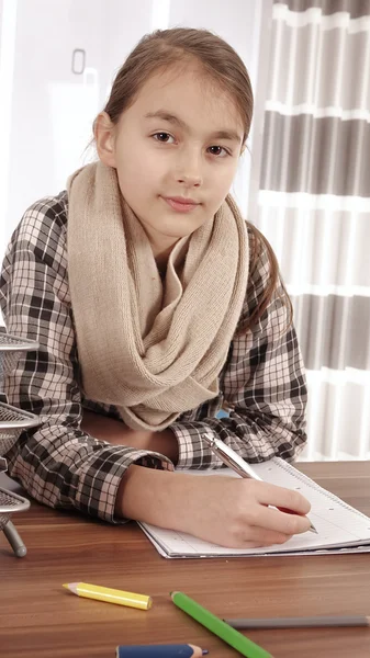 Little girl working on her school project at home.