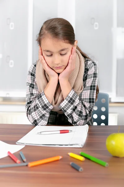 Little girl working on her school project at home.