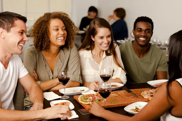 Group of friends laughing in a restaurant