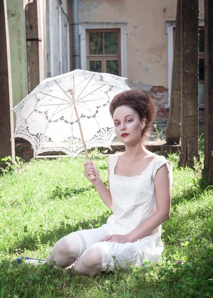 Beautiful young gothic girl in white shirt with umbrella