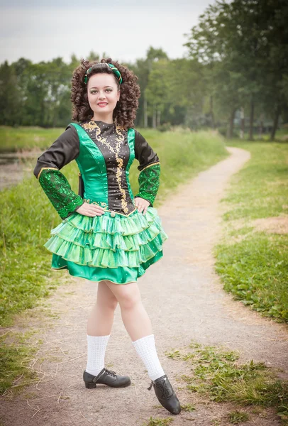 Young beautiful girl in irish dance dress and wig posing