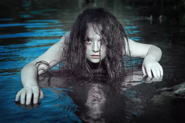 Young beautiful drowned ghost woman in the water