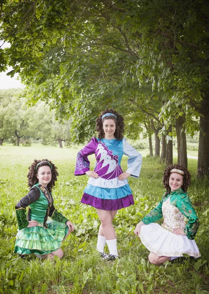 Three young beautiful girls in irish dance dress posing outdoor