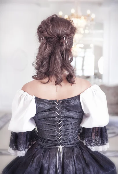 Beautiful medieval woman in dress, back