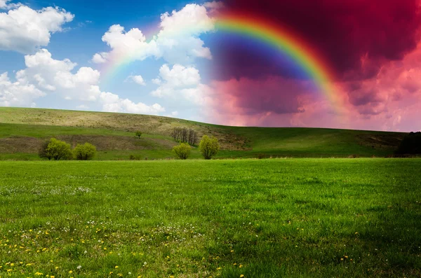 Green field with rainbow, day and night concept