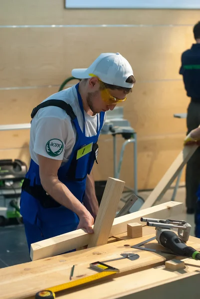 Young carpenter performs task of competition