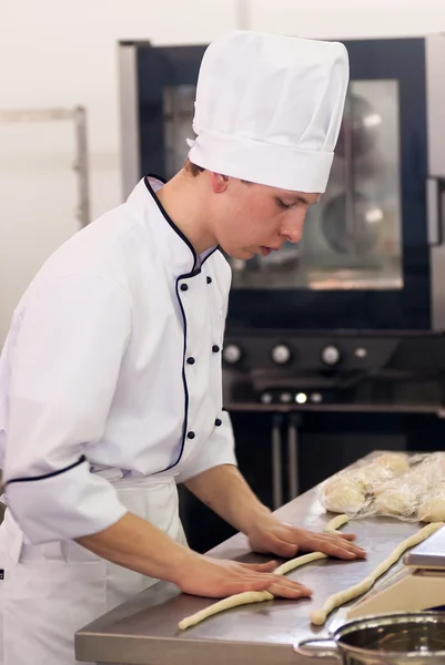Young cook prepares food in competition