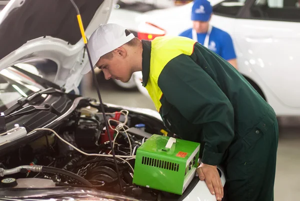 Young car mechanic passes competition stage.Tyumen