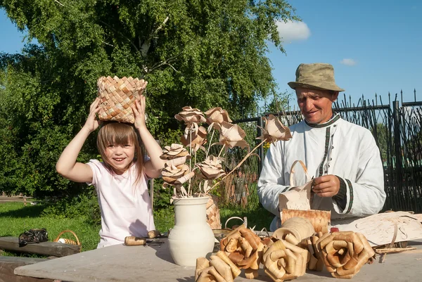 Master of wooden products with granddaughter