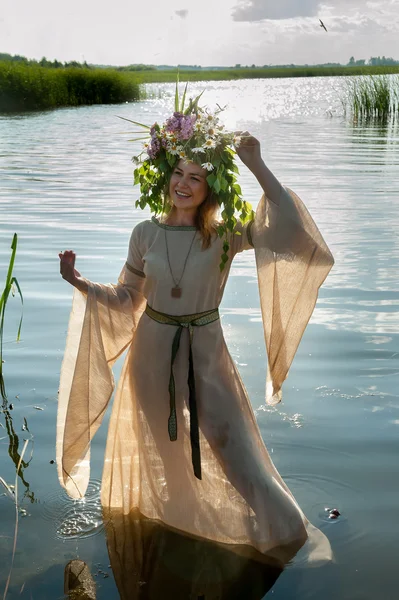 Beautiful sad woman with flower wreath