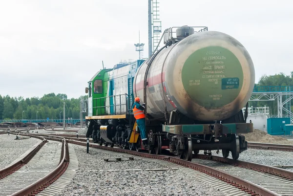 Shunting locomotive transports tank on other way