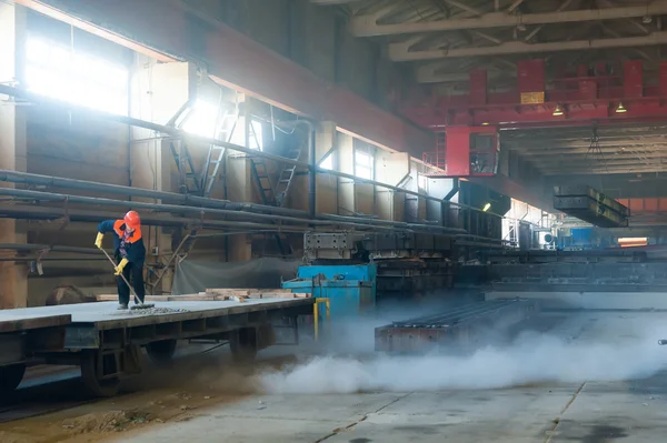 Worker cleans railway platform