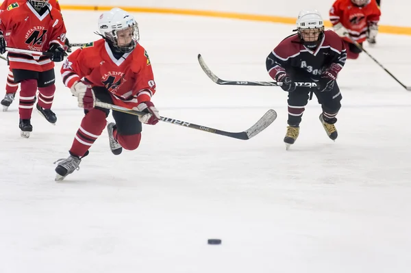 Game moment of children ice-hockey teams