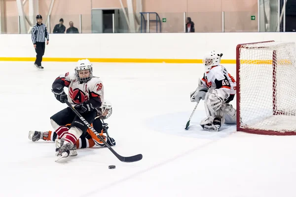 Attack in game between children ice-hockey teams