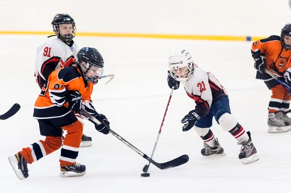 Game between children ice-hockey teams