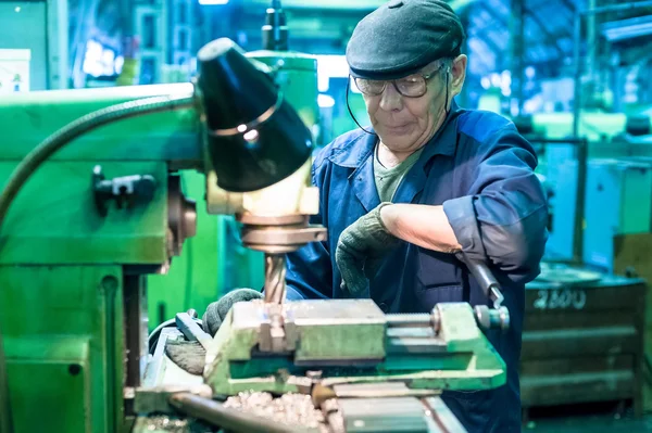 The milling-machine operator works at the machine