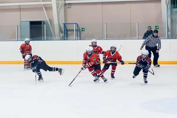 Game moment of children ice-hockey teams