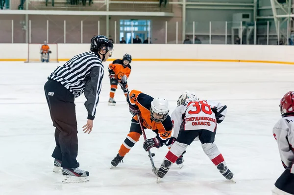 Puck playing between players of ice-hockey teams