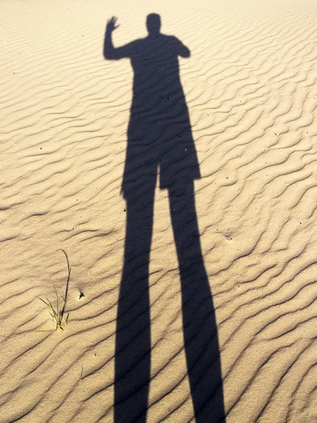 The shadow of a man on the sand