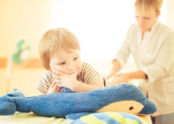 Boy on massage therapy couch