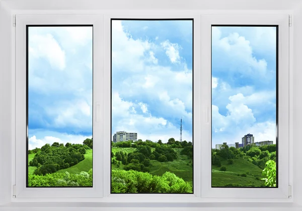 Modern plastic window with a view of the sky, nature and city