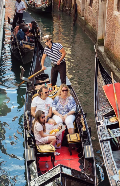 Family sailing in gondola in Venice