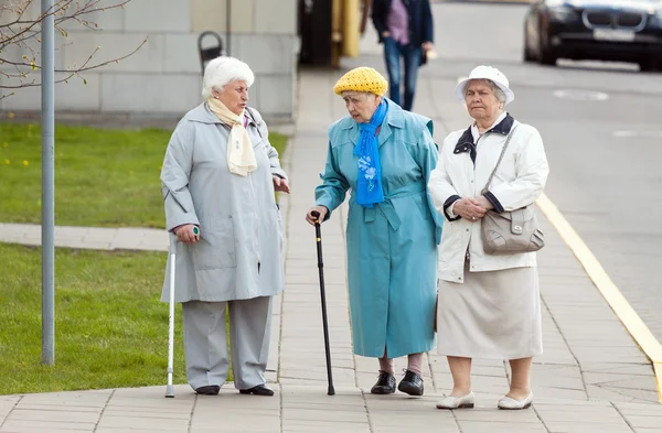 Aged senior women walking on the street