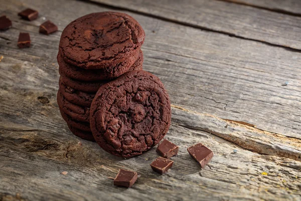 Soft chocolate cookies set on old wooden surface