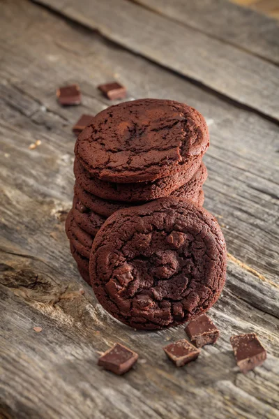 Soft chocolate cookies set on old wooden surface