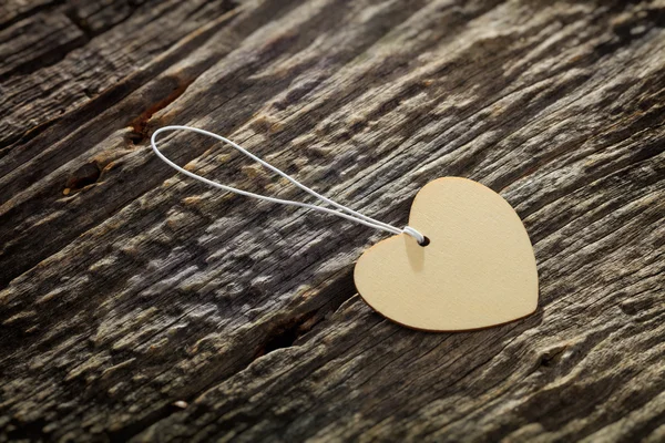 Carton heart shaped label with rope