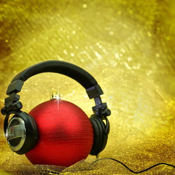 Christmas ball with headphones in glittering background