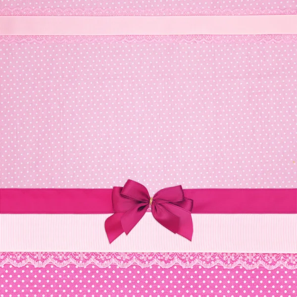 Pink retro polka dot textile background with ribbons and bow