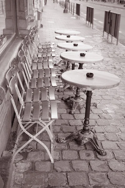 Cafe Tables and Chairs in Wet Rainy Street in Brussels
