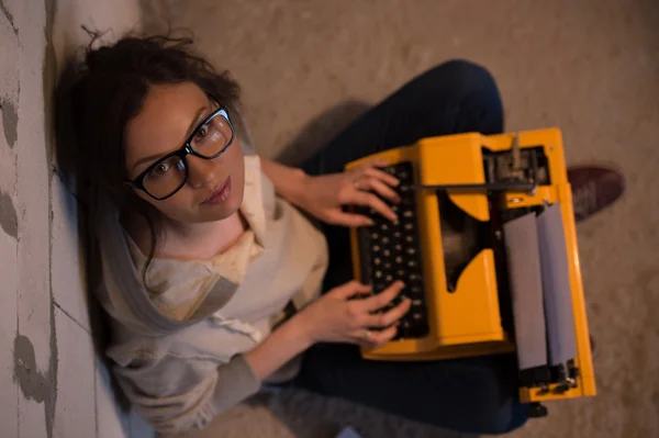 Woman typing using typewriter