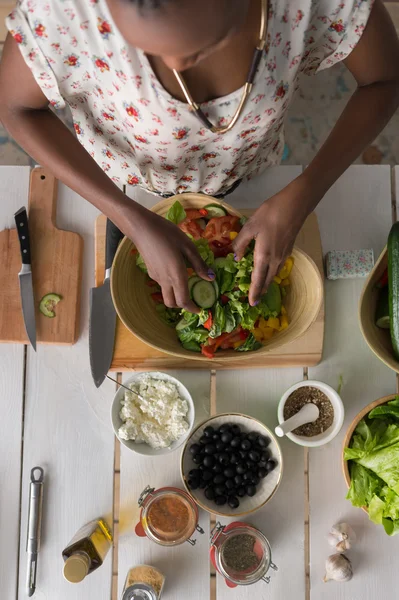 African Woman preparing Salad