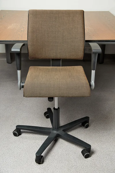 Stylish Brown office chair in front of a wooden meeting desk