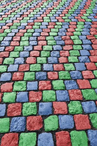Red green blue colored cobbled road