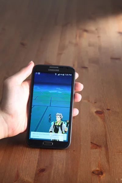 Player with Pokemon go on smartphone