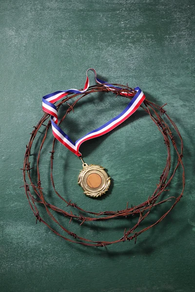 Medal surrounded by the barbwire